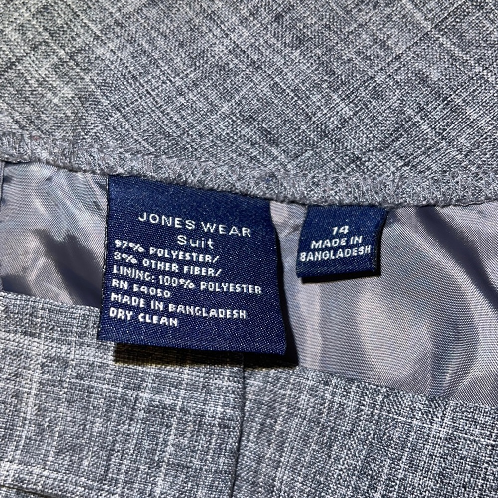 COPY - Jones wear grey suit with light navy and blue strips intertwined